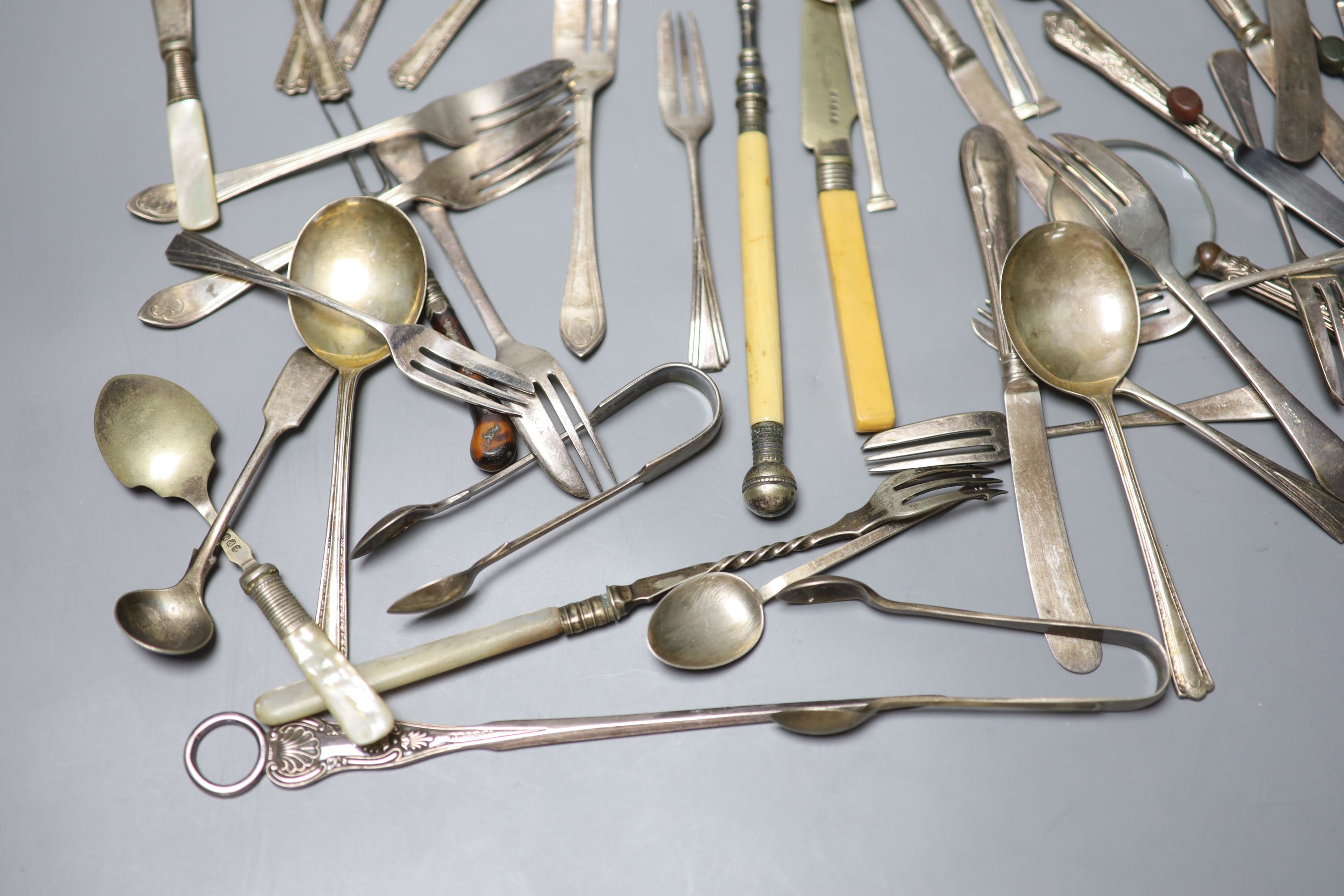 Two sets of silver spoons including bean end coffee spoons, six silver handled tea knives and a silver handled magnifyer etc.